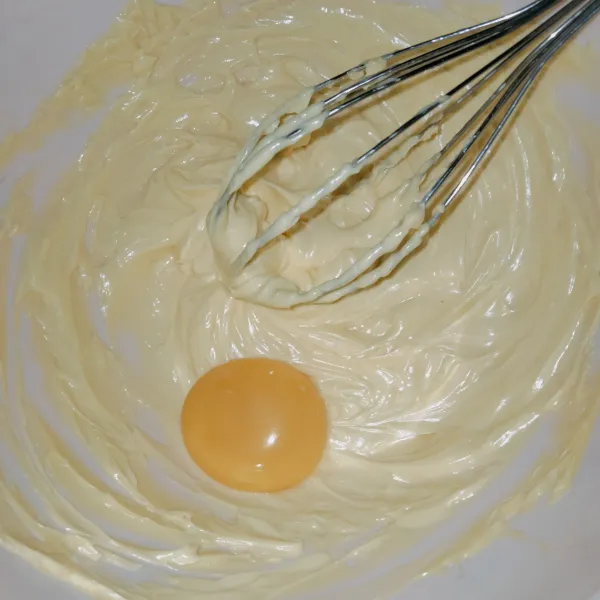 Masukkan kuning telur dan garam lalu kocok hingga mengembang