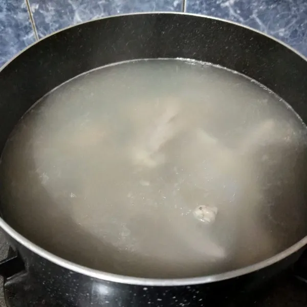 Didihkan air bersama bawang putih geprek. Setelah mendidih, masukkan daging ayam. Beri garam, dan masak hingga empuk.