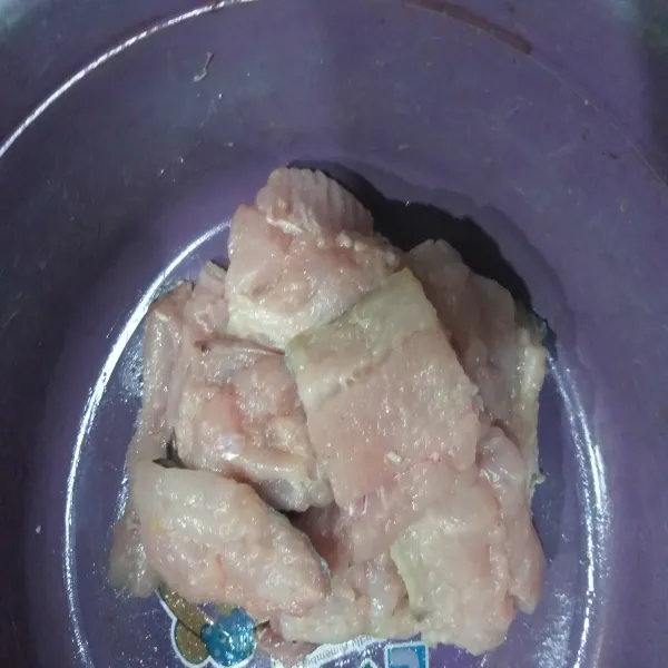 Cuci bersih ikan kemudian lumuri air jeruk lalu potong-potong