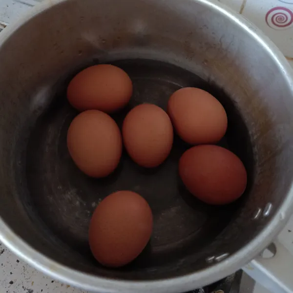 Rebus telur ayam, kupas lalu sisihkan.