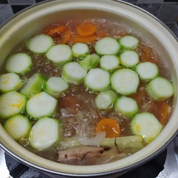 Masukkan irisan wortel rebus sampai ½ matang, lalu masukkan oyong masak sampai ½ matang