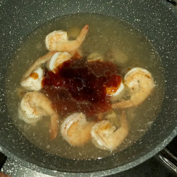 Setelah tumisan udang berubah warna, tuang air dan masukkan campuran saus. Masak sampai mendidih.