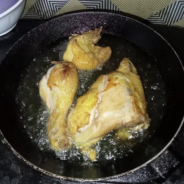 Goreng ayam yang sudah direbus tadi hingga kekuningan, tiriskan.