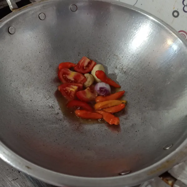 Goreng cabe, tomat, bawang dan kemiri dengan sedikit minyak sampai layu.