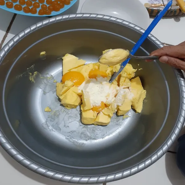 Di wadah lain siapkan margarin dan kuning telur, aduk rata dengan spatula.