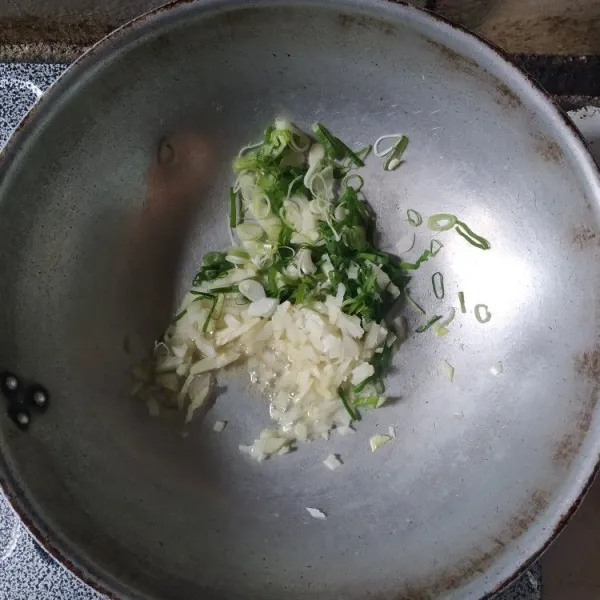 Tumis bawang bombay dan daun bawang hingga harum.