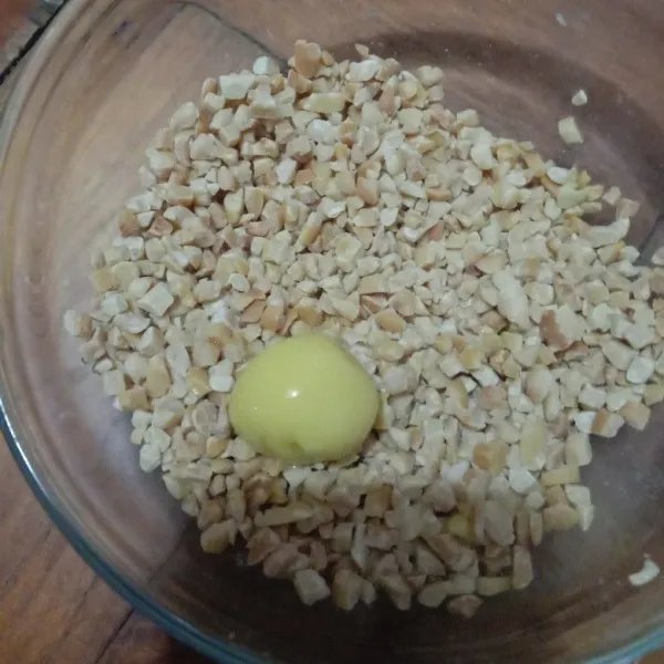 Masukkan ke dalam kocokan putih telur, lalu gulingkan pada kacang cincang.