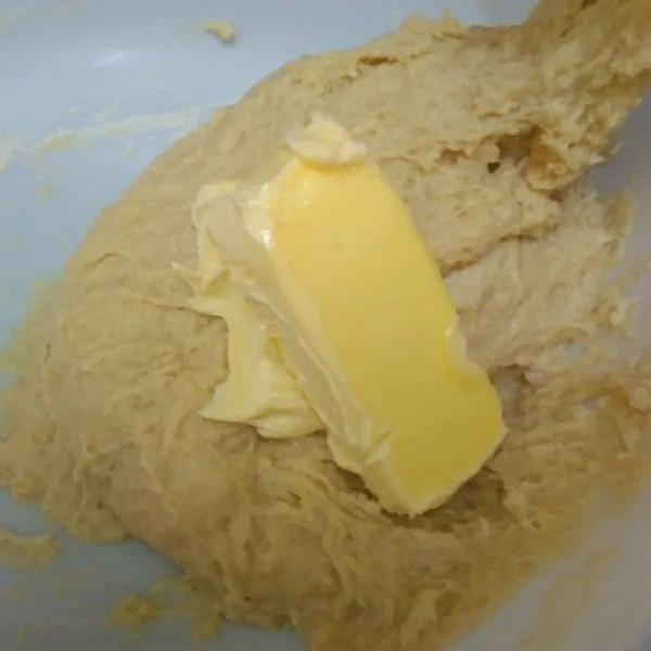 Siapkan wadah, campur tepung terigu, gula pasir, susu bubuk, dan telur lalu aduk rata. Masukkan larutan ragi lalu uleni hingga rata. Masukkan butter dan garam, uleni hingga kalis.