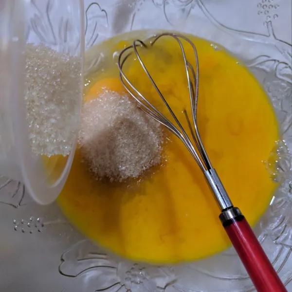Dalam wadah, kocok 4 butir telur dengan gula pasir, kocok hingga gula larut.