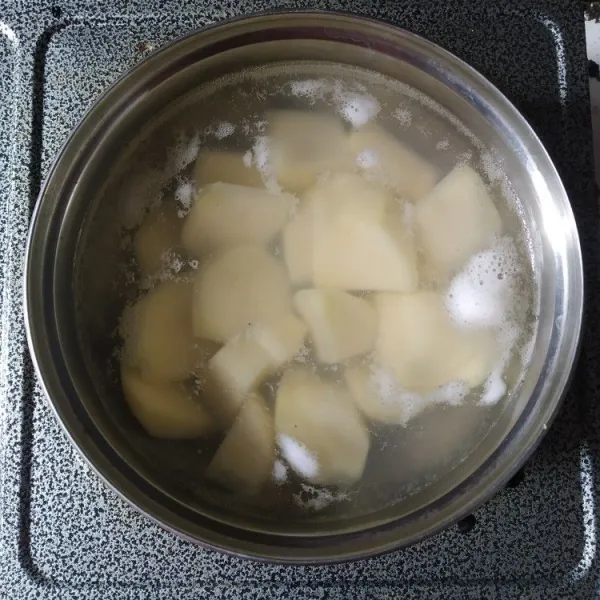 Kupas, cuci bersih dan potong kentang, kemudian rebus hingga empuk.