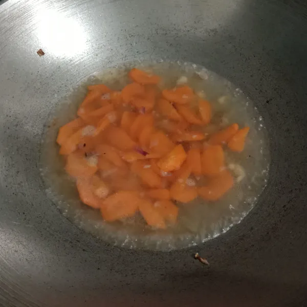 Kemudian masukkan wortel. Tuang air, masak hingga wortel setengah matang.