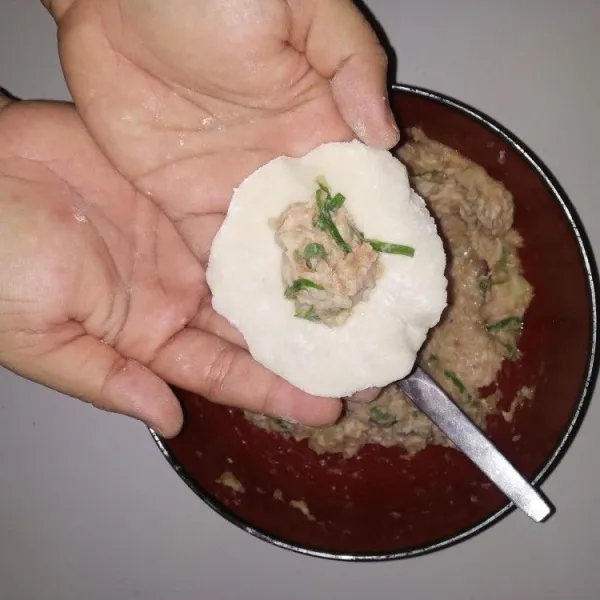 Siapkan kulit gyoza, kemudian isi dengan adonan filling ayam dan tutup rapat buat kerutan dipinggiran.