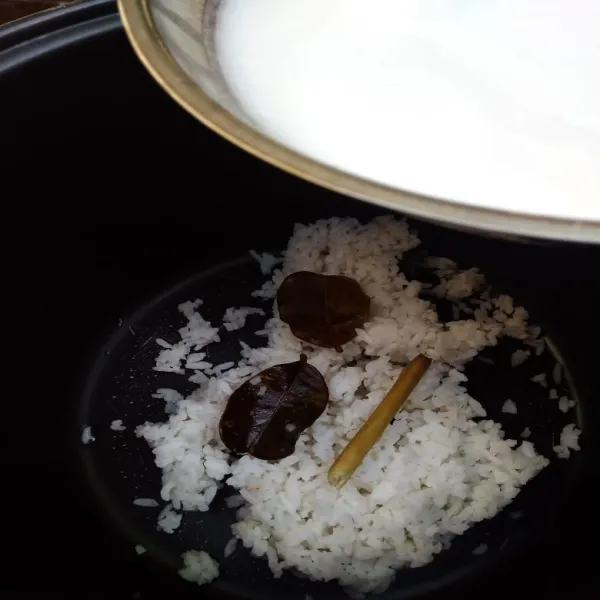 Masukkan nasi sisa dan santan, sereh, daun jeruk, garam ke dalam magic jar, koreksi rasa. Tekan tombol cook. biarkan matang.