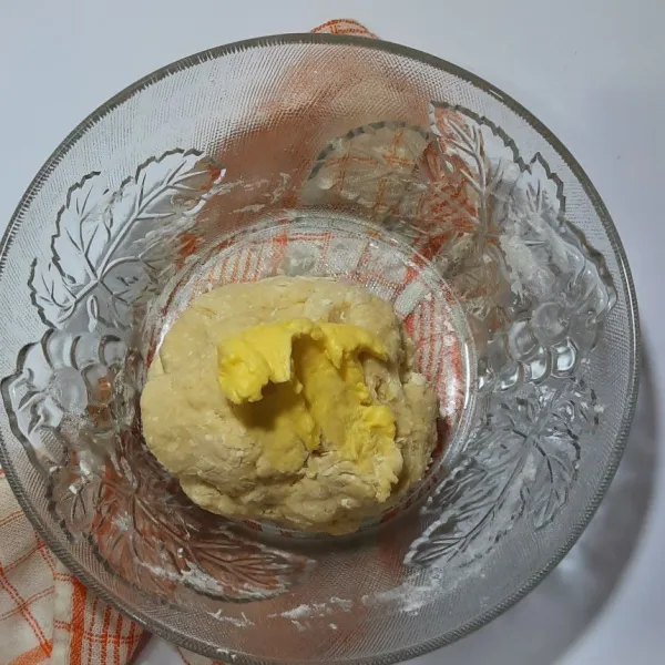 Tambahkan margarin sedikit demi sedikit sambil diuleni hingga kalis elastis.