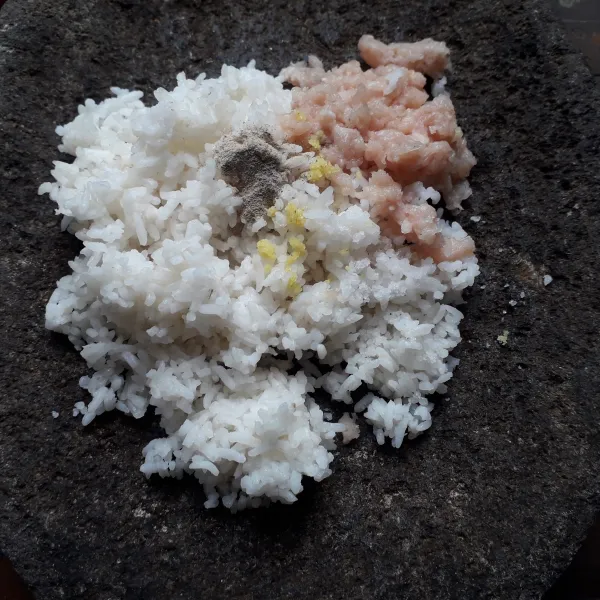Letakkan nasi, ayam cincang, bumbu halus, merica bubuk, garam dan kaldu bubuk ke ulekan.