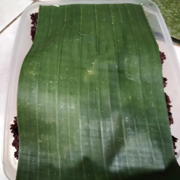 Tutup atasnya dengan daun pisang, lalu tutup wadah/panci. Biarkan 3 hari, hingga mengeluarkan aroma khas tape. (Jangan dibuka selama proses permentasi).