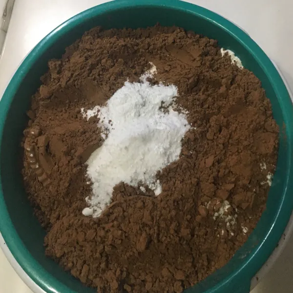 Ayak tepung terigu, coklat bubuk, baking powder, soda kue, dan vanili ke dalam satu wadah.