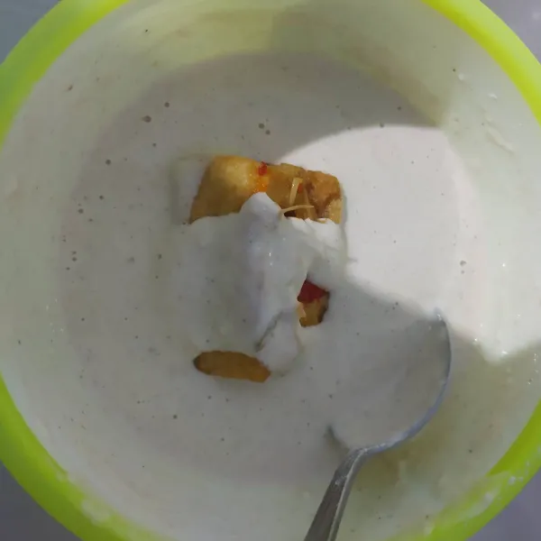 Masukkan tahu isi kedalam adonan tepung, ratakan.