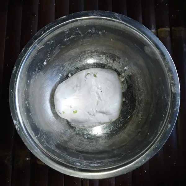 Tuang sedikit demi sedikit air panas kedalam campuran tepung sambil diuleni, sampai adonan bisa dipulung, hati-hati jangan terlalu encer.