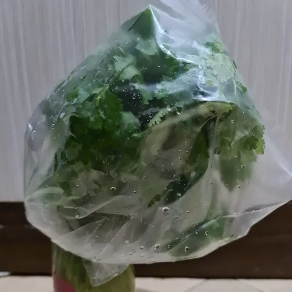 Siapkan plastik bersih, lalu tutup daun ketumbar.