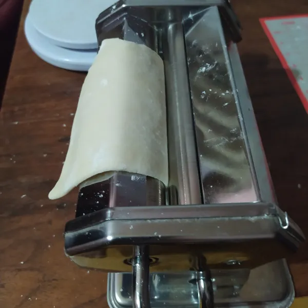 Setelah itu, uleni lagi dan bagi jadi menjadi empat bagian. Giling dengan ampia secara bertahap sampai tipis.