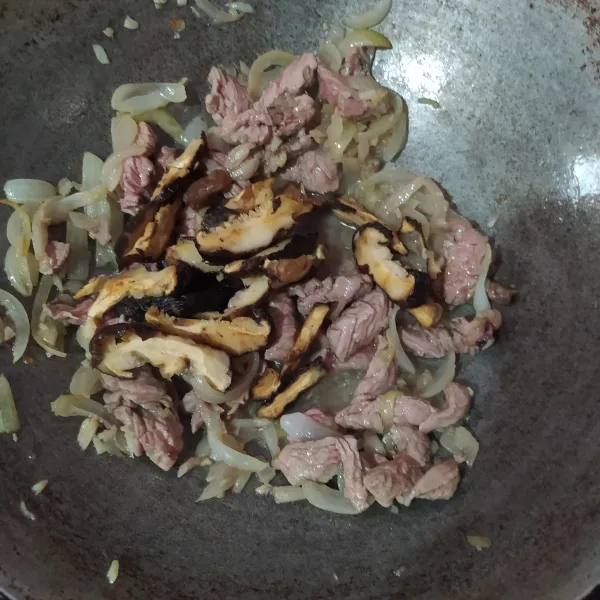 Masukkan irisan jamur shitake (setelah direndam tadi, bilas lalu peras airnya dan diiris memanjang). Bumbui dengan minyak wijen, secukupnya garam, lada bubuk, dan kecap asin. Tambahkan sedikit air dan masak hingga empuk.