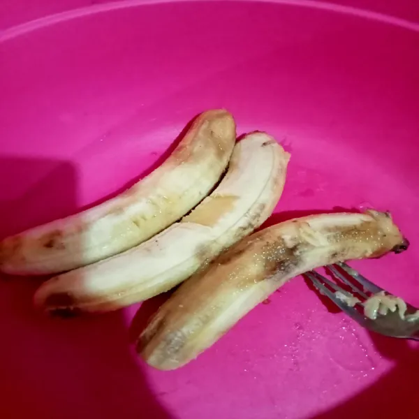 Hancurkan buah pisang menggunakan garpu hingga pisang halus.