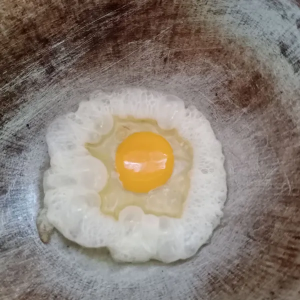 Panaskan sedikit minyak goreng di wajan. Kemudian ceplok telur, goreng sampai matang.