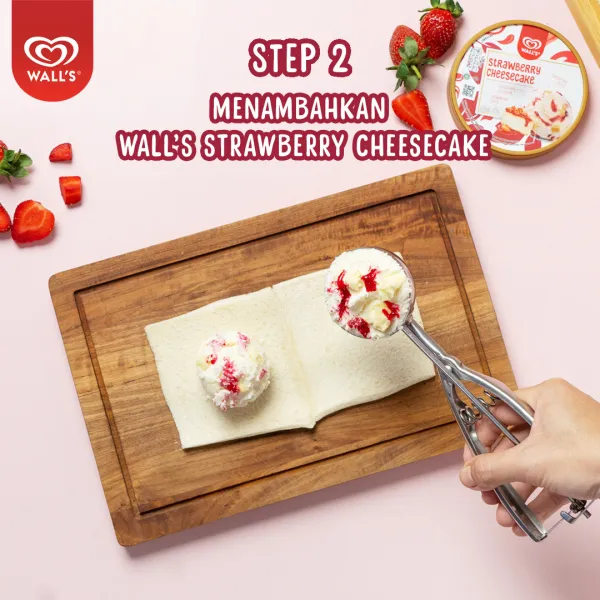 Tuang 2 scoop Wall’s Strawberry Cheesecake, lalu bentuk menjadi bola dan bungkus dengan plastik wrap, bekukan dalam freezer.