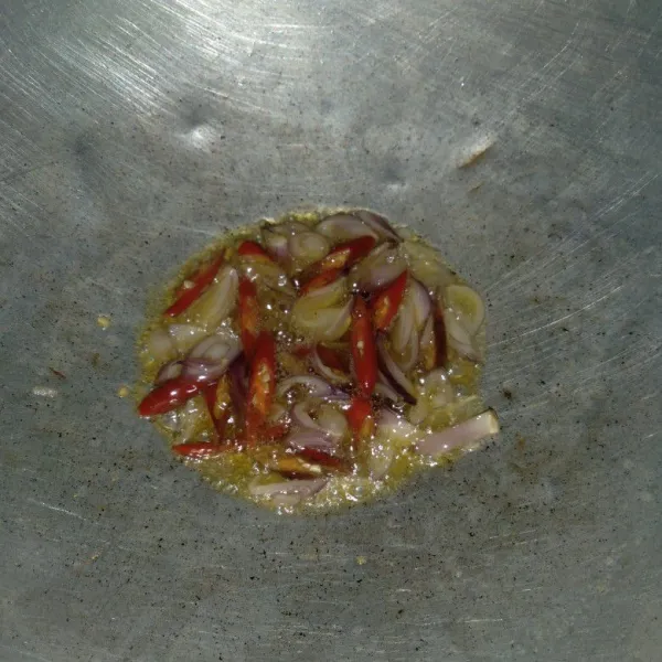 Tumis irisan bawang merah dan cabai merah hingga layu.