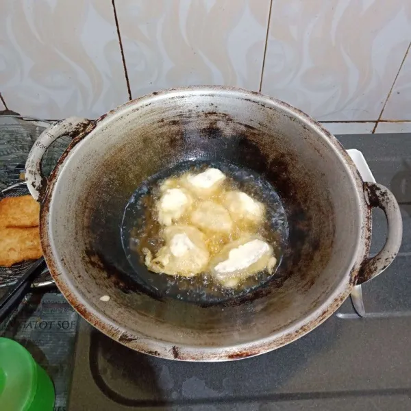 Balur ikan dengan adonan tepung, lalu goreng hingga matang.