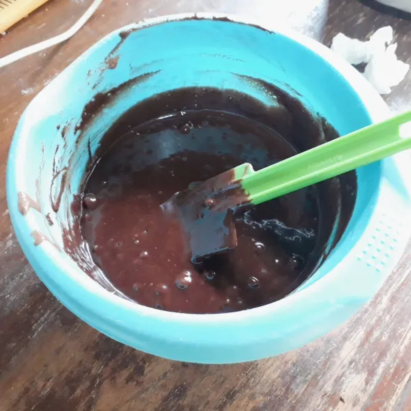 Tambahkan cokelat leleh, aduk rata dengan spatula.