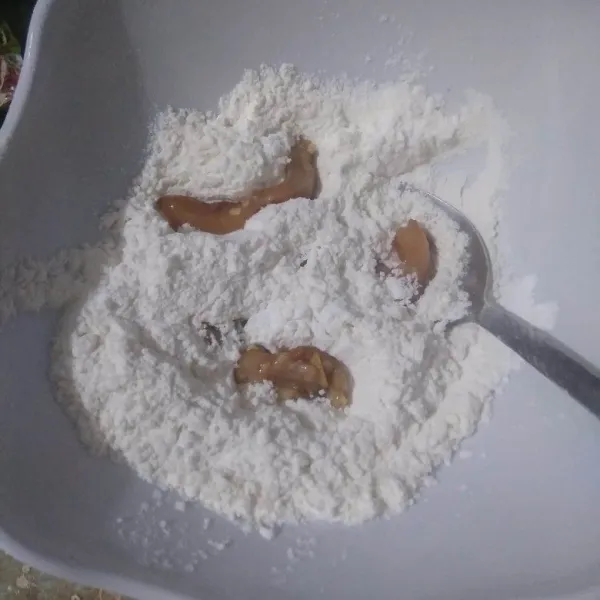 Masukkan potongan ayam ke dalam tepung. Balur rata sambil diremas-remas, agar bumbu dan tepung menempel sempurna ke seluruh sisi ayam.