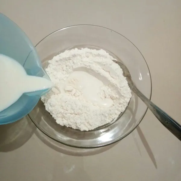 Masukkan tepung terigu, baking powder, gula pasi,r dan garam ke dalam mangkok. Tambahkan susu cair sedikit demi sedikit sambil di aduk hingga tercampur rata.
