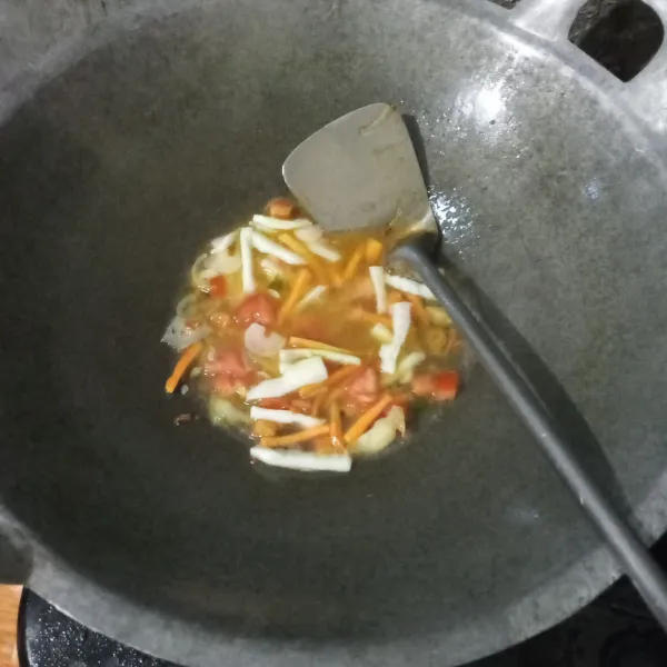 Masukkan tomat, wortel, timun lalu tuang air. Masak hingga wortel empuk.