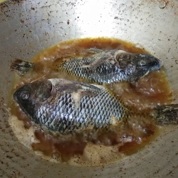 Goreng ikan nila hingga matang dan kering, lalu tiriskan.