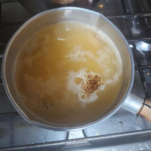 Masukkan jagung, lalu beri lada dan garlic powder (bubuk bawang putih).