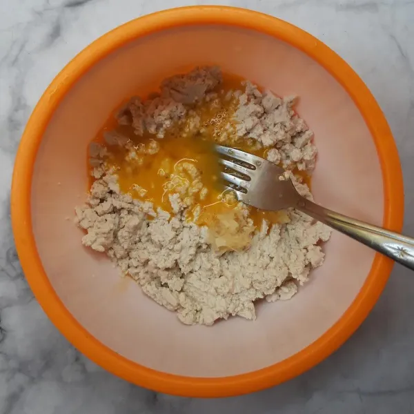 Beri bawang putih halus, aduk rata. Tambahkan telur. Aduk rata.