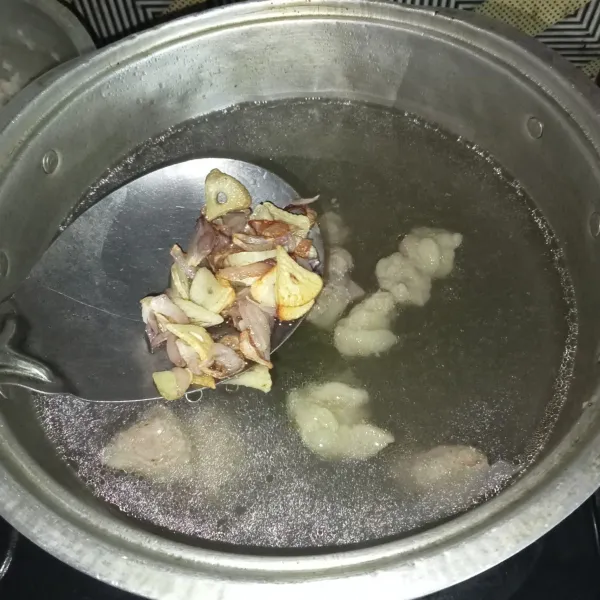 Masukkan bawang yang sudah ditumis kedalam panci rebusan daging.