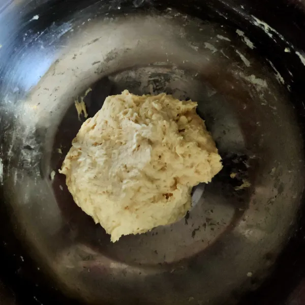 Tuang air ragi tadi ke dalam tepung, aduk hingga merata (adonan lengket).