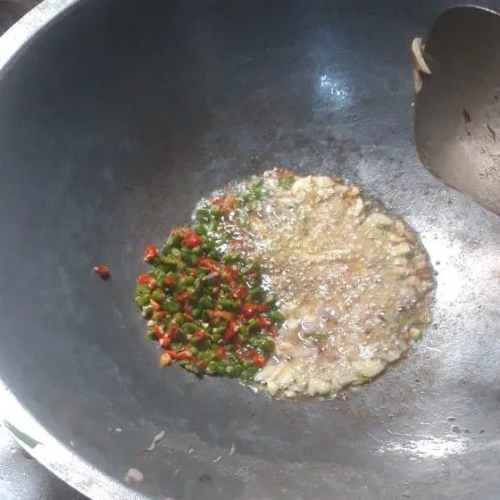 Tumis bawang putih hingga harum, masukkan cabai lalu aduk rata.