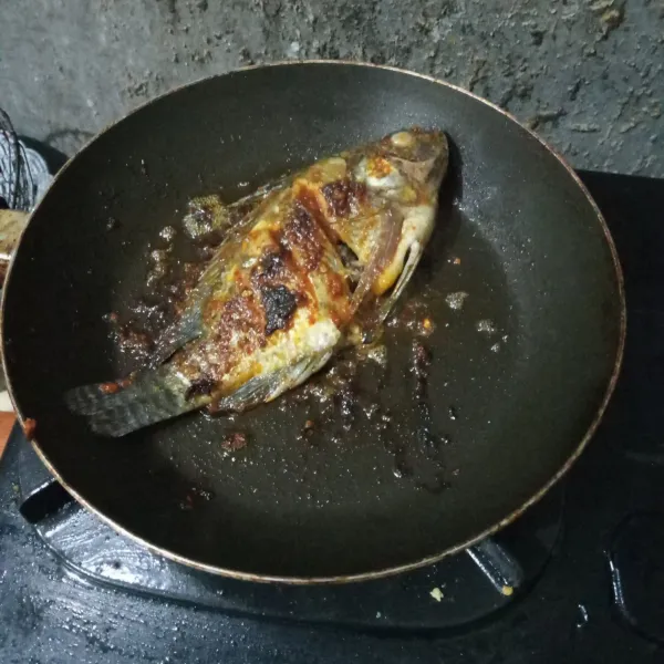 Oles teflon dengan margarin lalu masukkan ikan. Bakar ikan hingga matang di kedua sisi sambil diolesi sisa bumbu.
