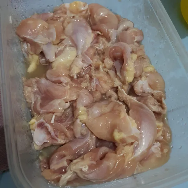 Ayam yang sudah dibersihkan, lumuri dengan bawang putih dan kecap asin. Diamkan selama 30 menit sampai meresap.