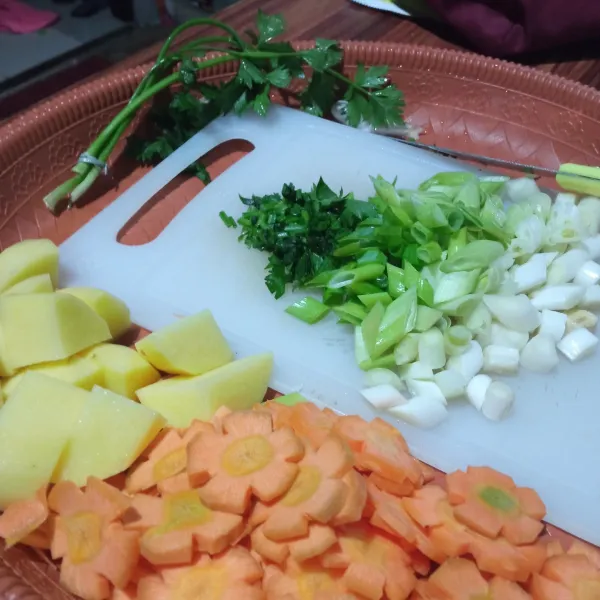 Potong semua bahan sayur yaitu wortel, kentang, bawang prei, dan daun seledri