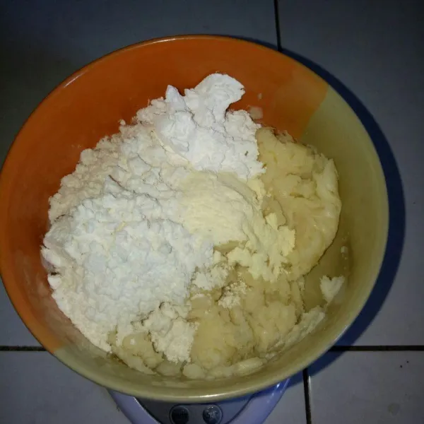 Setelah tape halus, tambahkan terigu, tapioka dan susu bubuk. Aduk jadi satu sampai tercampur rata