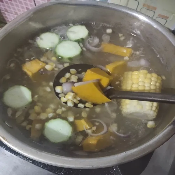 Rebus air, lalu masukkan bawang merah, labu kuning, jagung, dan oyong. Masak hingga empuk.