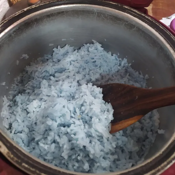 Masak beras dengan air rebusan bunga telang seperti biasa (saya menggunakan magic com). Setelah matang, aduk dan sisihkan sampai nasi menjadi dingin.