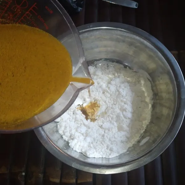 Larutkan bumbu ayam ungkep dan kaldu bubuk dengan air, tuang ke dalam campuran tepung sedikit demi sedikit