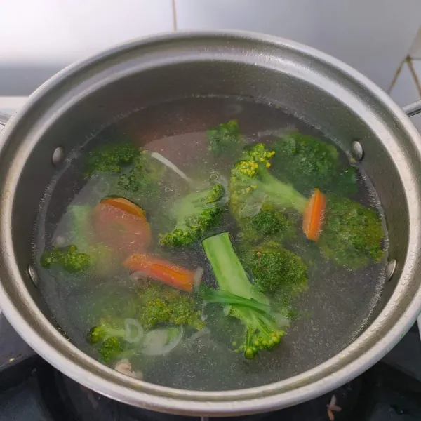 Tambahkan brokoli dan air, masak hingga mendidih.