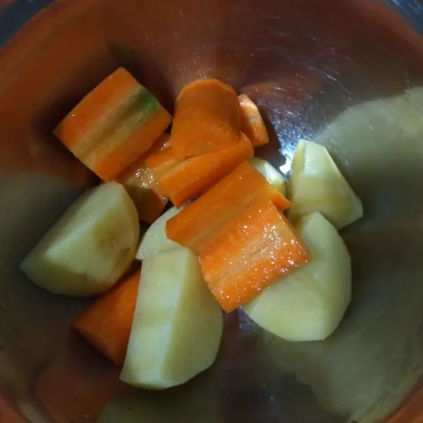 Potong kentang dan wortel sesuai selera.